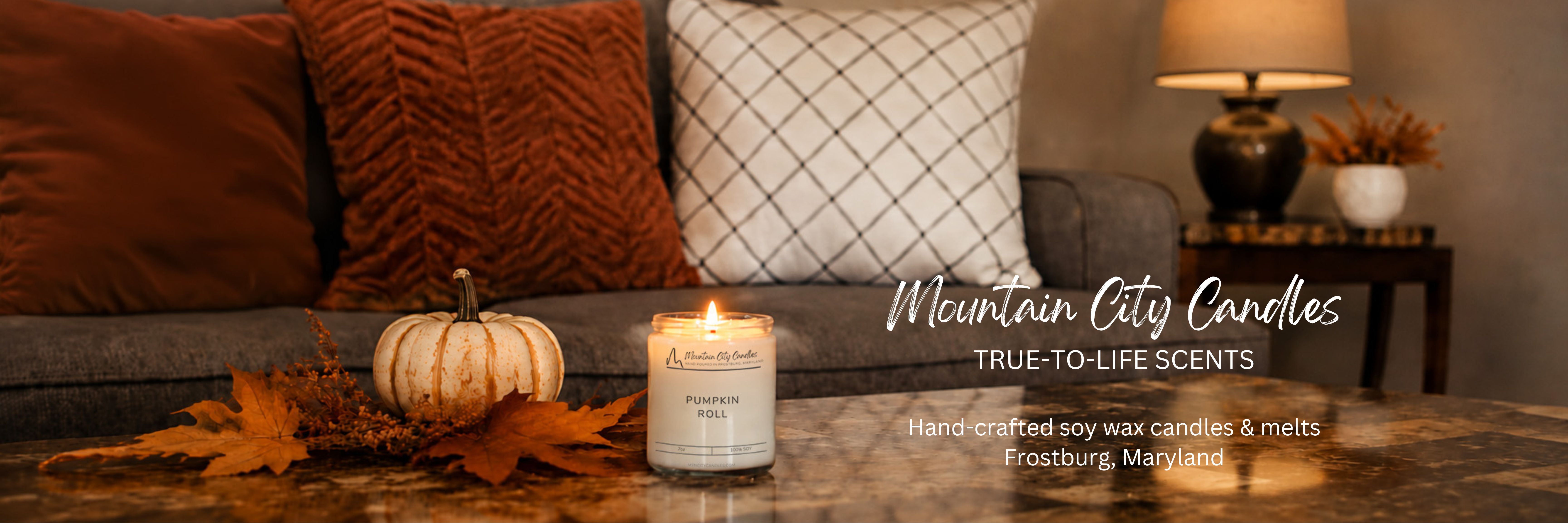 soy wax 7oz candle on a table in front of a fall decorated sofa